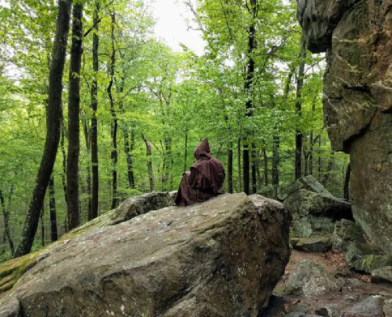 hermit meditating on a rock